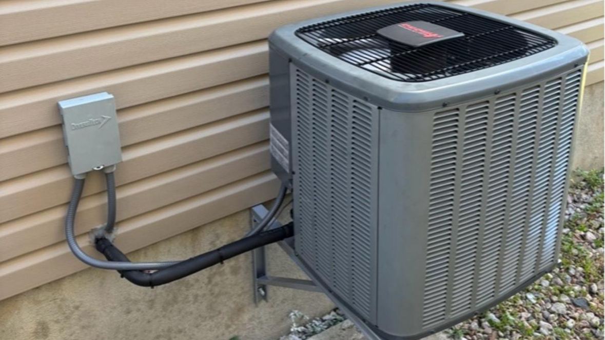 A new air conditioner condenser beside a house