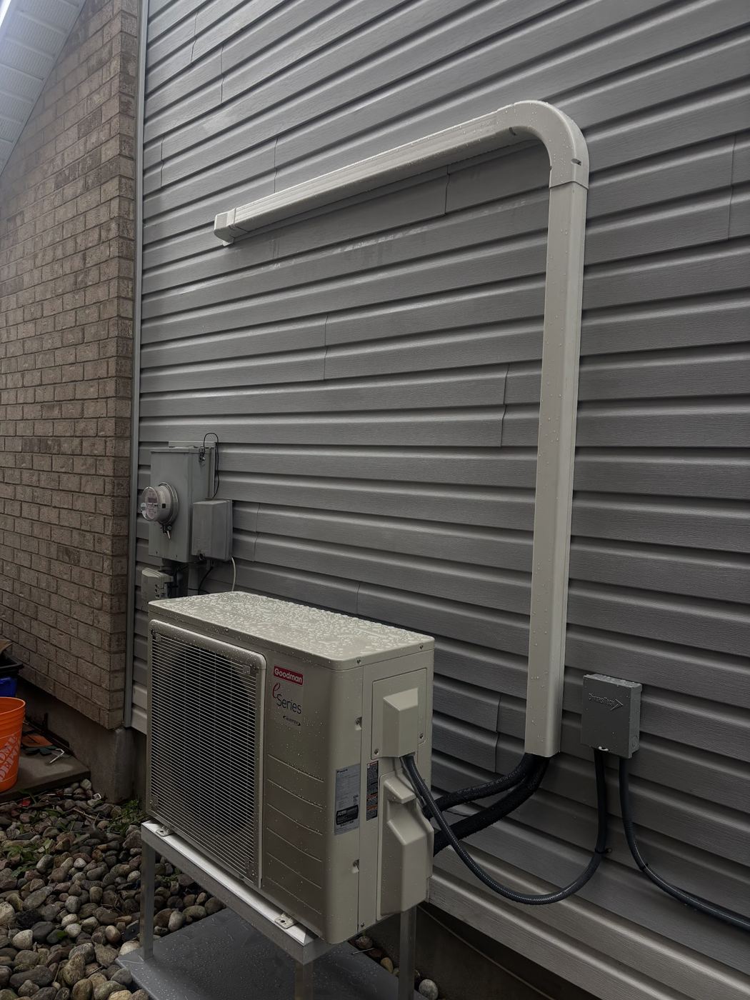 A mini-split outdoor unit on a wall bracket