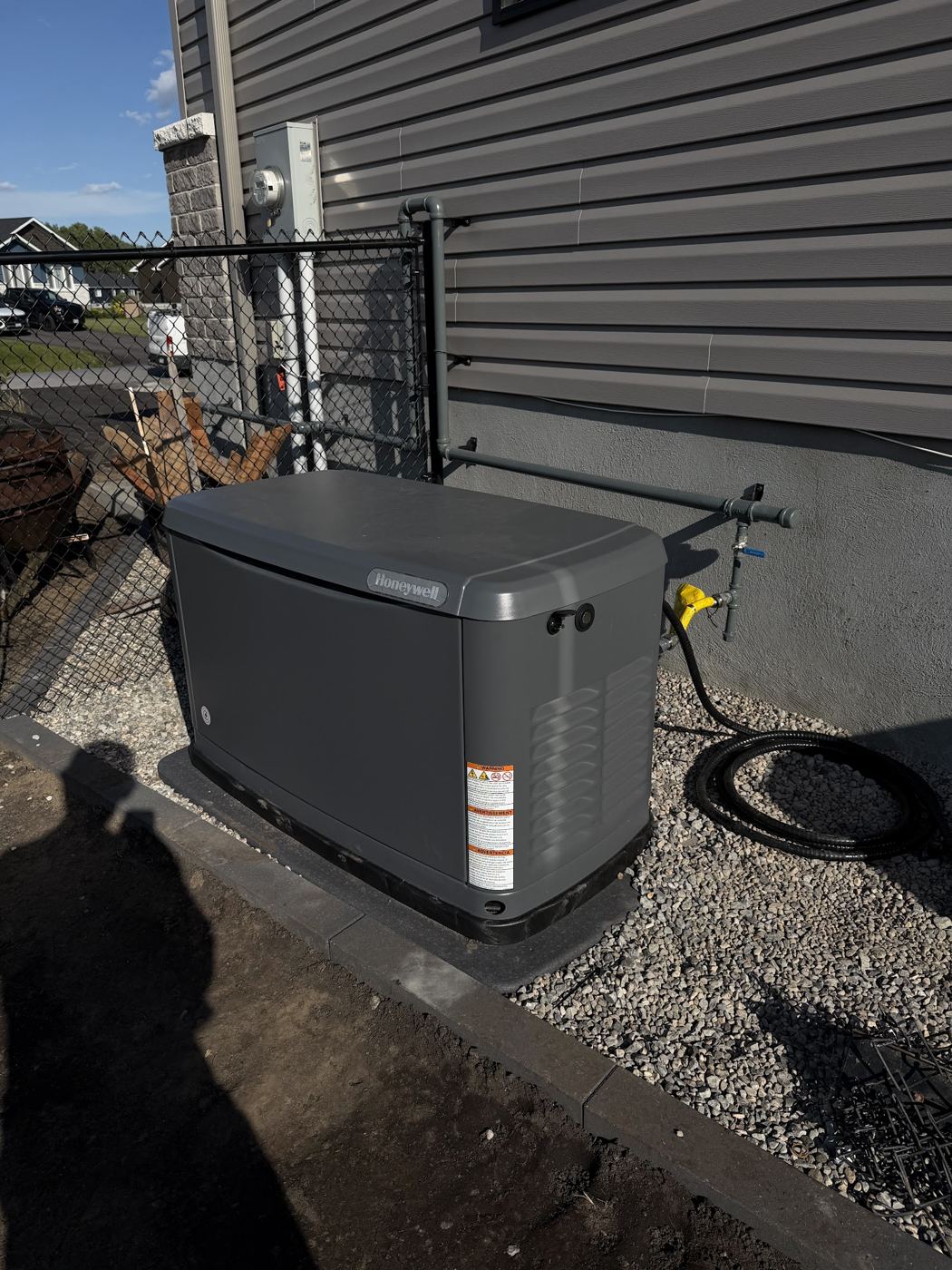 A standby generator beside a house