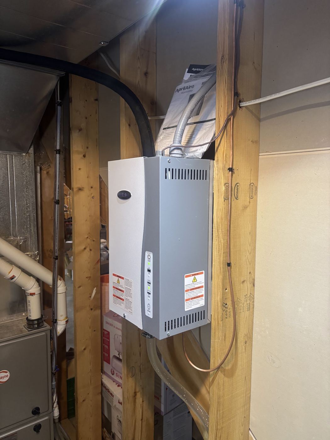 A tankless water heater mounted in a basement
